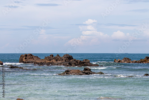 View of Wediombo Beach, Yogyakarta, Indonesia with a row of corals breaking the waves photo