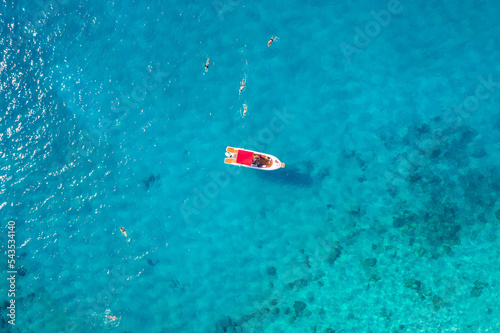 Aerial view beautiful white yacht on clear blue sea. Concept cruise travel by drone © Parilov