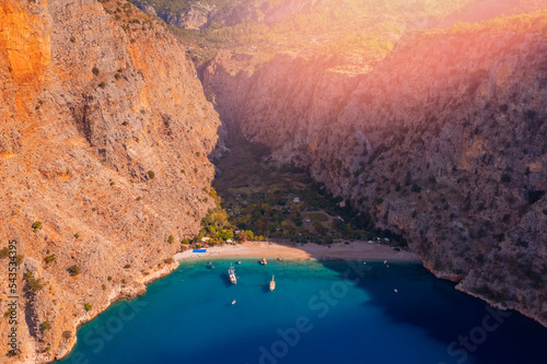 Fototapeta Naklejka Na Ścianę i Meble -  Amazing beach Butterfly Valley with blue water in Oludeniz Fethiye Turkey, aerial top view