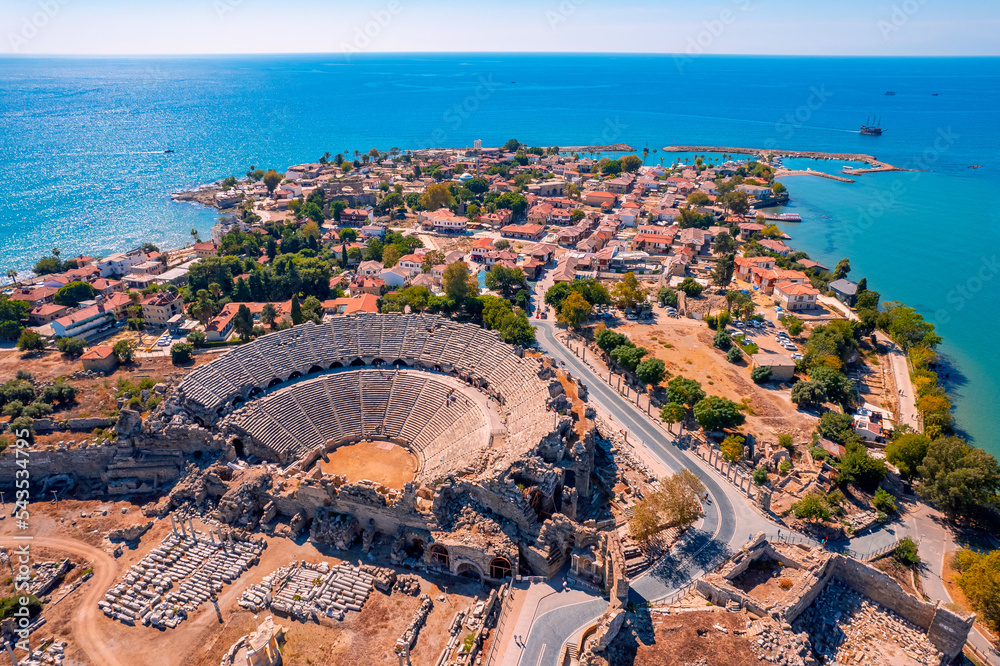 Fototapeta premium Antique amphitheater of ancient Side city Antalya Turkey drone photo, aerial top view