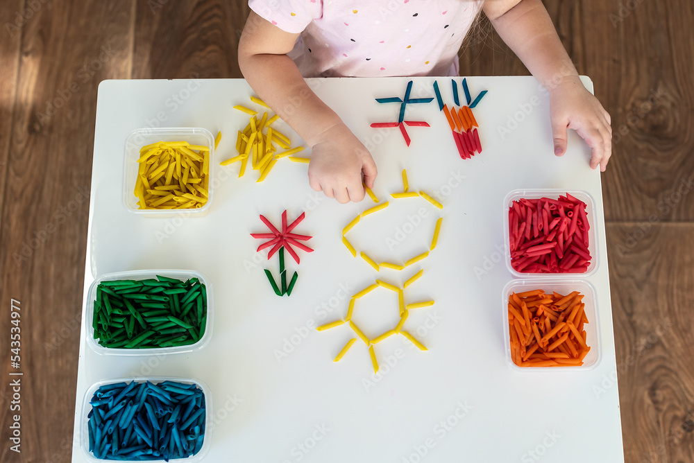 Child Hands Playing With Dyed Pasta For Sensory Play And Craft