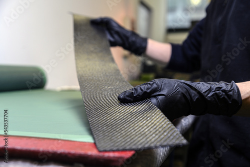 Preparation and cutting of a real carbon fiber sheet for the industrial production of a component for sports cars