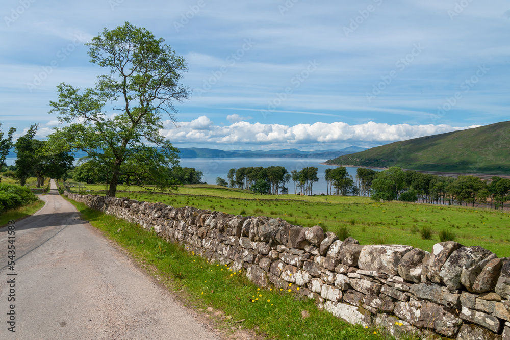 Scottish country road with stone wall,leading to Applecross village,Highlands of Scotland,UK.
