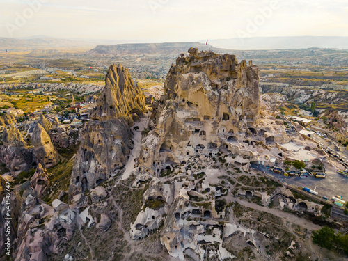 Panoramic drone view of the volcanic rock formations, towers, cones, cave houses carved in stone, Cappadocia, the Central Anatolia Region of Turkey. High quality photo photo