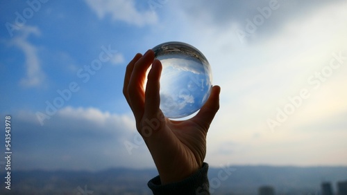 Person holding a crystal ball photo