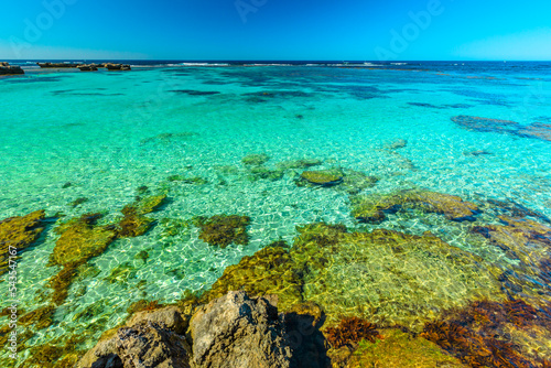 Tourism in Perth. Rottnest Island, Western Australia. Scenic view from roks over tropical reef in turquoise crystal clear sea of Little Salmon Bay, a paradise for snorkeling, swimming and sunbathing.