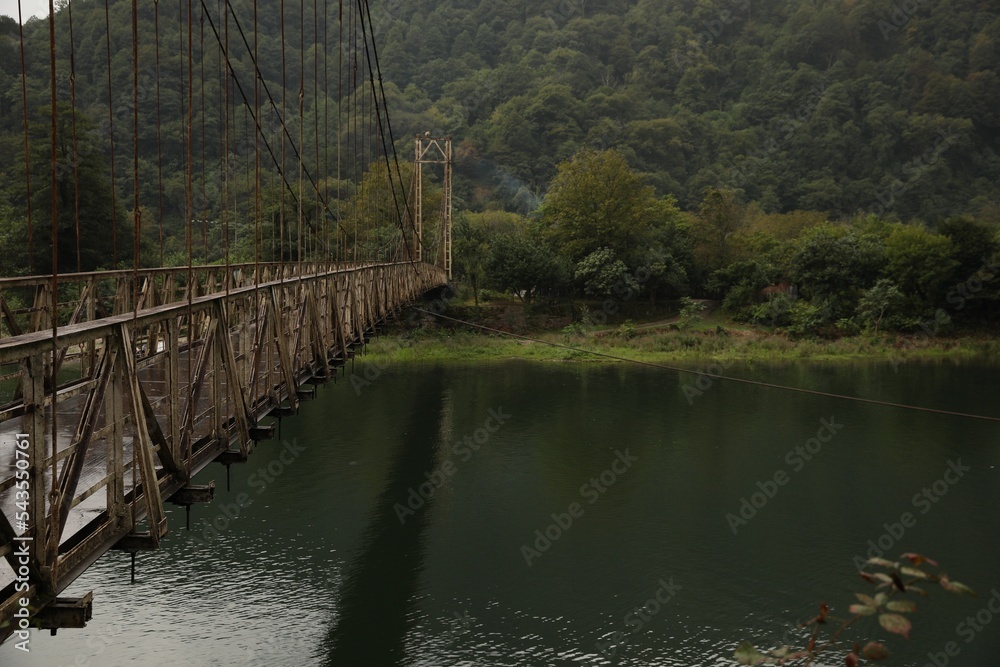 Fototapeta premium Beautiful view on rusty metal bridge over river in mountains