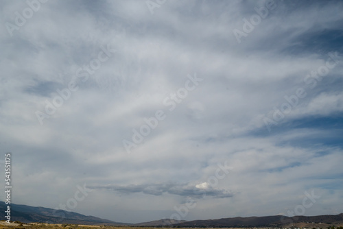 Washoe Lake State Park high desert landscape featuring a cloud in the distance on a blue sky day copy-space and green grass, Nevada, USA photo