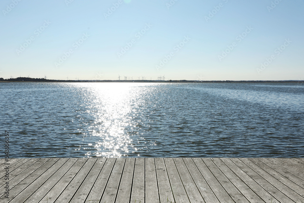 Beautiful view of wooden terrace near river on sunny day