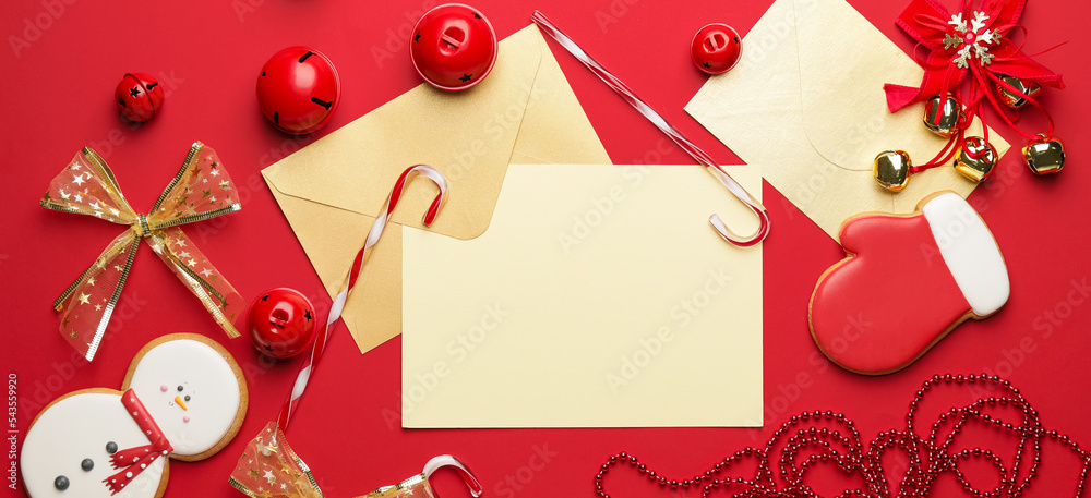 Empty paper sheet with envelope and Christmas decorations on red background Empty paper sheet with envelope and Christmas decorations on red background