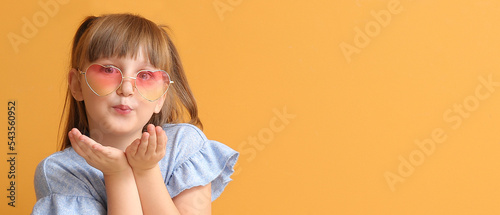 Cute little girl blowing ki...