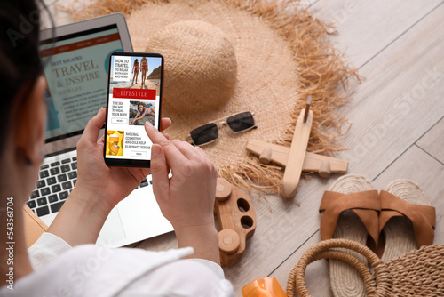 Female travel blogger using...