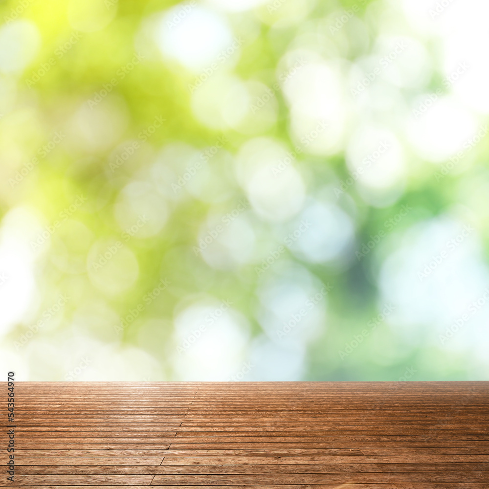 Empty wooden surface against blurred green background. Bokeh effect Empty wooden surface against blurred green background. Bokeh effect