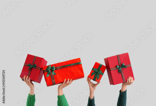 Hands holding red gift boxe...