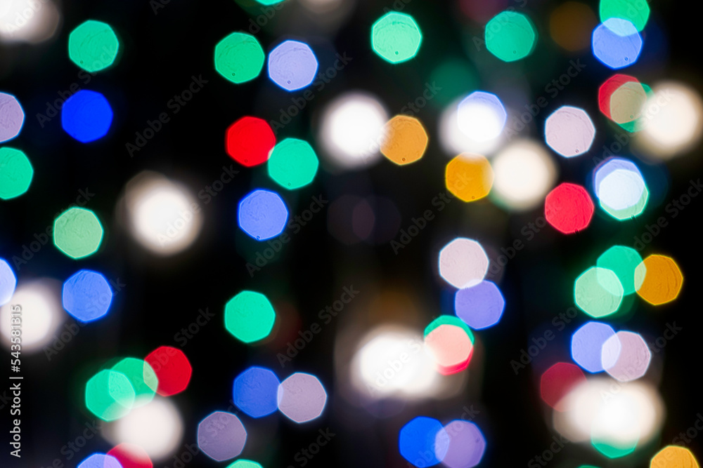 Fototapeta premium multicolored festive lights on a black background screensaver backdrop