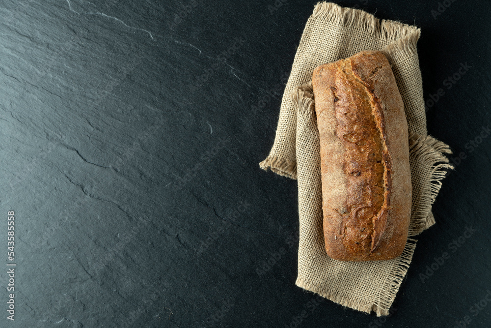 Sourdough bread with crispy crust on wooden shelf. Bakery goods Stock
