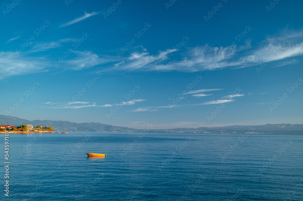 Alone Boat in clear blue Mediterranean sea. Summer Vacation photo. Edit space.