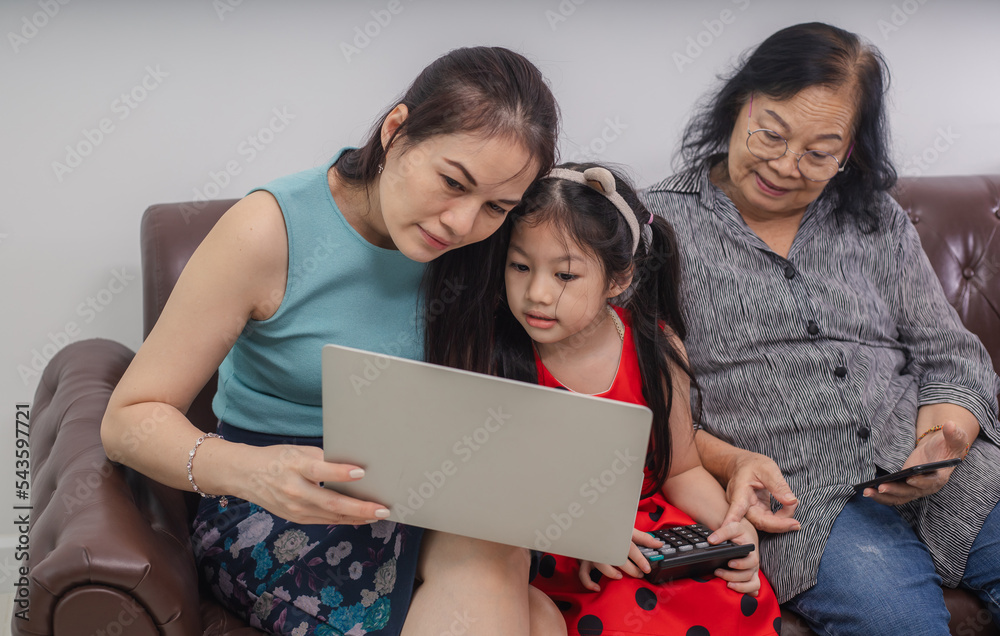 Happy three generations of women sit relax on couch laugh watching funny video on laptop Happy three generations of women sit relax on couch laugh watching funny video on laptop
