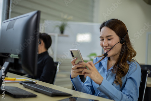 Asian telemarketing agent in call center office