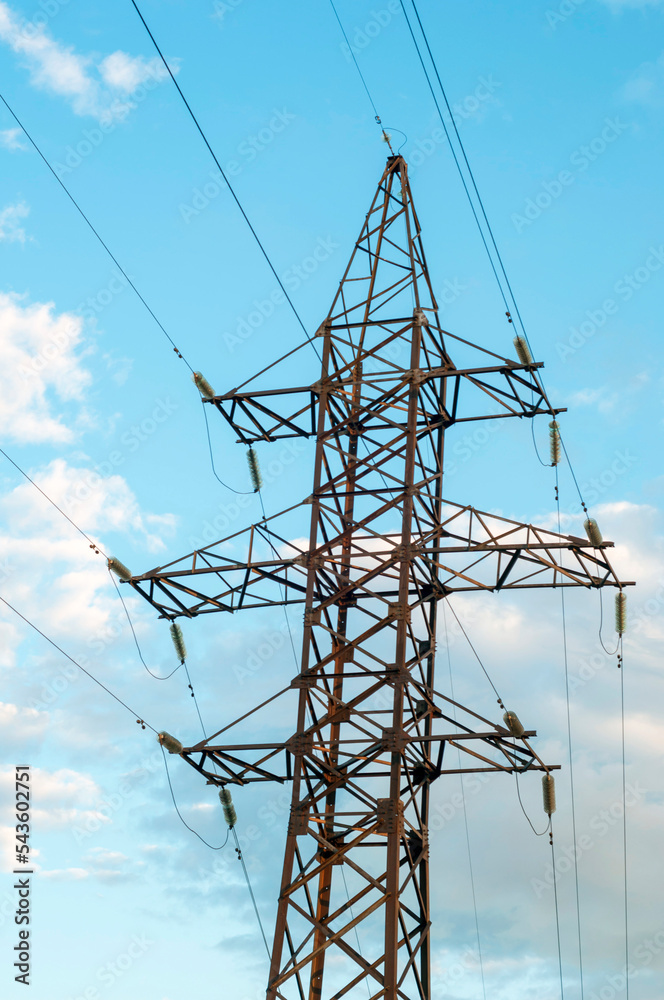 power line against a blue sky with white clouds. vertical snapshot.