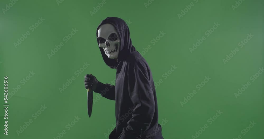 Scary Man In The Hooded Sweatshirt Wearing Halloween Mask Stabbing With A Knife And Turning To Camera Making Threatening Gesture On The Green Screen Background
Scary Man In The Hooded Sweatshirt Wearing Halloween Mask Stabbing With A Knife And Turning To Camera Making Threatening Gesture On The Green Screen Background
