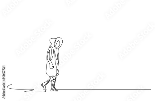 person walking outside in the cold winter in winter clothes