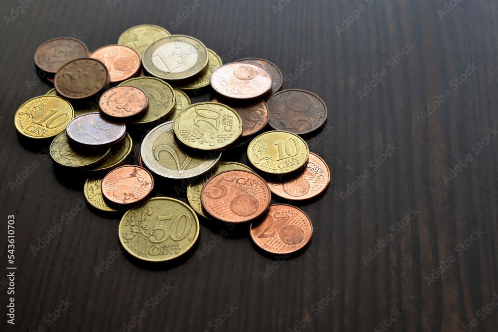 Euro cent coins on wood table. Copy space is on the right side. Euro cent coins on wood table. Copy space is on the right side.