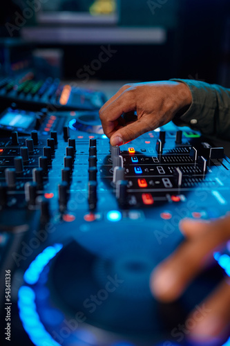 Closeup male hand on sound mixer console