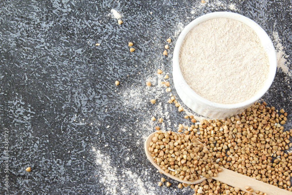 Buckwheat flour in a white bowl and wooden spoon, raw green buckwheat grain. Alternative flour, gluten free flour Buckwheat flour in a white bowl and wooden spoon, raw green buckwheat grain. Alternative flour, gluten free flour