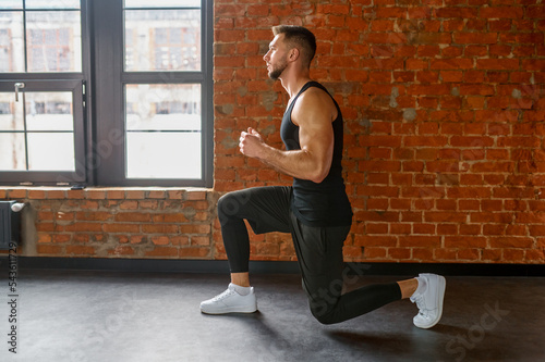 Muscular, sportive man practicing squats