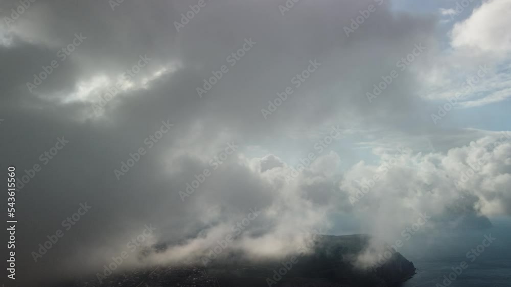 Aerial view. The drone flies over foggy and fluffy clouds. Blue sky sun and sea fog. Abstract aerial nature summer ocean sunset sea and sky background. Vacation, travel and holiday concept Aerial view. The drone flies over foggy and fluffy clouds. Blue sky sun and sea fog. Abstract aerial nature summer ocean sunset sea and sky background. Vacation, travel and holiday concept