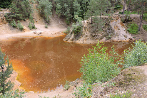 A view of a purple lakelet in Rudawy Janowickie, Sudetes mountains, Poland, a mining excavation flooded with water