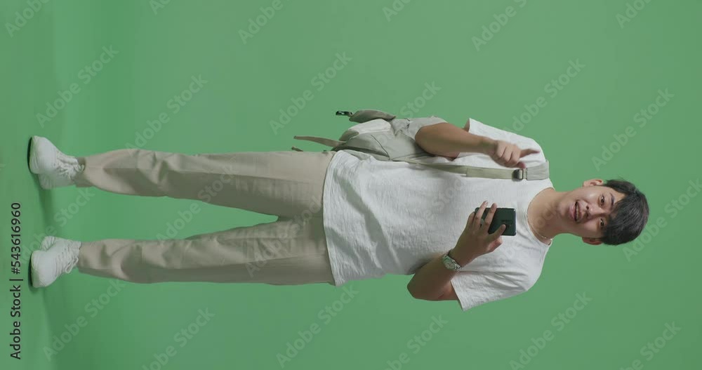 Full Body Of Asian Man Student Using Mobile Phone And Direct Fingers Side On Green Screen Studio
Full Body Of Asian Man Student Using Mobile Phone And Direct Fingers Side On Green Screen Studio