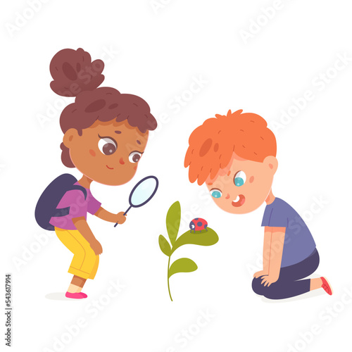 School children holding magnifying glass to watch ladybug on green plant in yard, garden