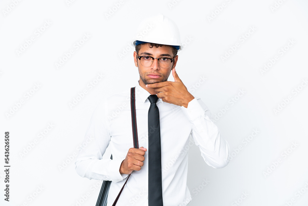 Architect brazilian man with helmet and holding blueprints thinking