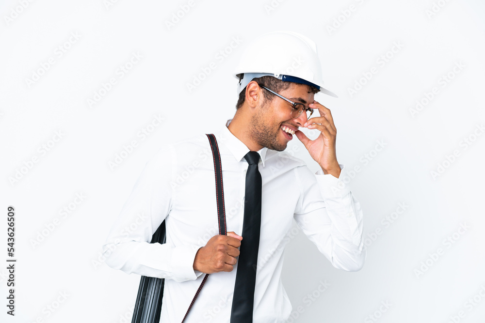 Architect brazilian man with helmet and holding blueprints laughing Architect brazilian man with helmet and holding blueprints laughing
