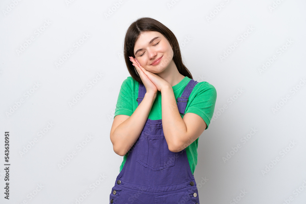 Young Russian woman isolated on blue background making sleep gesture in dorable expression Young Russian woman isolated on blue background making sleep gesture in dorable expression