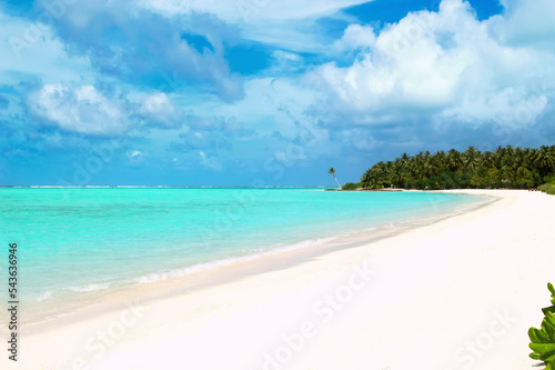 A deserted sandy beach on the Indian Ocean. Sunny day on the coast of the Maldives island