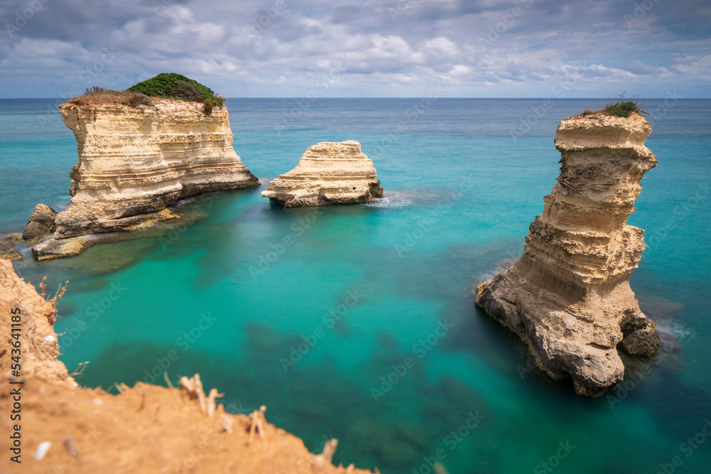 View at the Rock formation Faraglioni di Saint Andrea in Torre del Orso on the shores of the Adriatic Sea - Italy View at the Rock formation Faraglioni di Saint Andrea in Torre del Orso on the shores of the Adriatic Sea - Italy