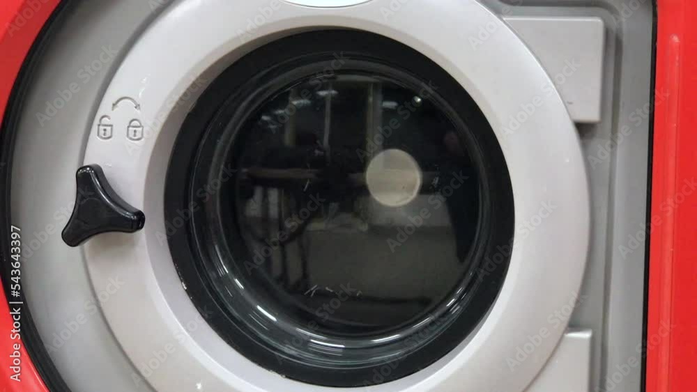 red washing machine at a laundromat 