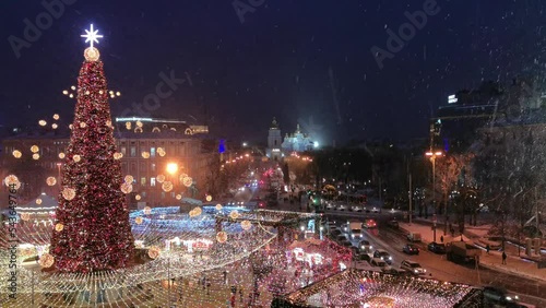 Christmas tree and Christmas fair on a snowy winter day in Sofievskaya Square, Kiev, Ukraine photo