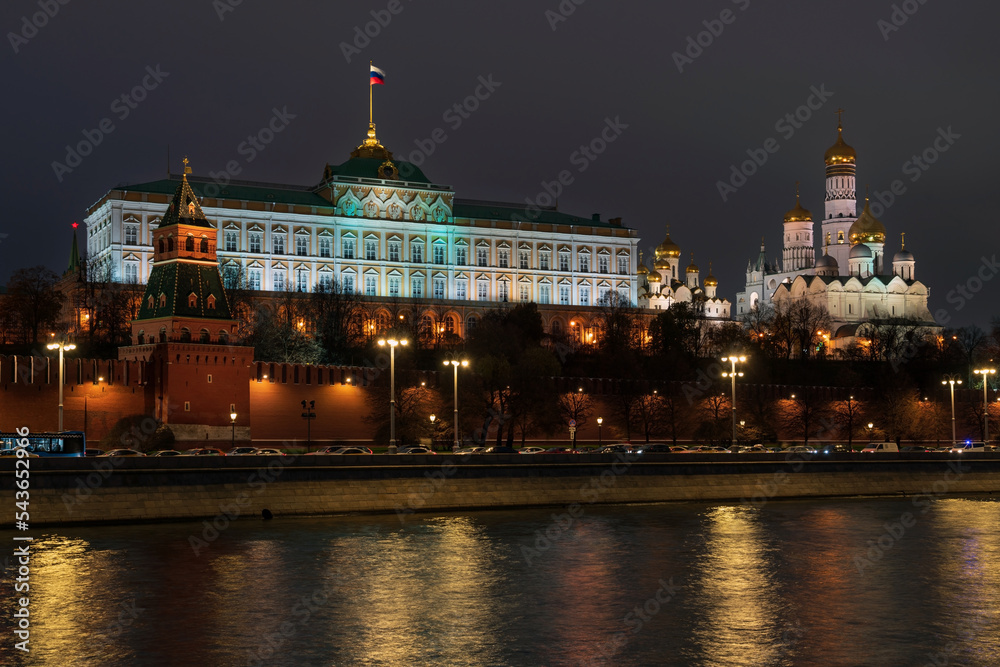 Fototapeta premium View of the building of the Grand Kremlin Palace, the Annunciation Tower and the ensemble of the Kremlin Cathedral Square from the embankment of the Moskva River with night lighting, Moscow, Russia
