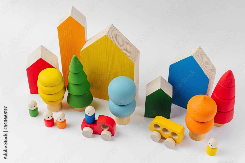 Colorful wooden toys. Houses, trees, toy cars and little men in the