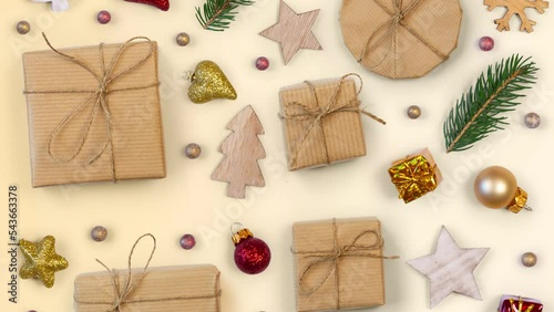 Moving Christmas decorations and gifts on bright background. Top view, flat lay, seamless looping. High quality 4k video.