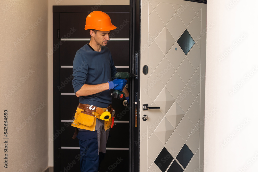 Drilling and installation of interior doors, the craftsman makes a hole