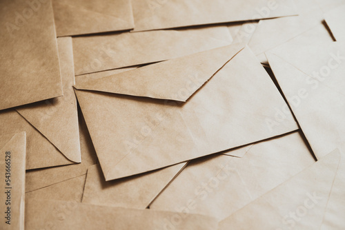 A stack of craft paper envelopes on a table.