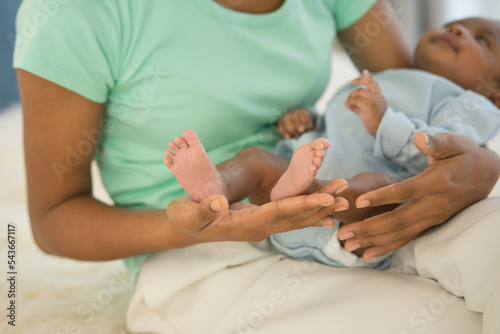 Close up newborn baby's foot tiny on hand mother holding little feet infant in her palm. family warm love caring for child in motherhood touching gentle clean finger toe. happy mother's day concept.