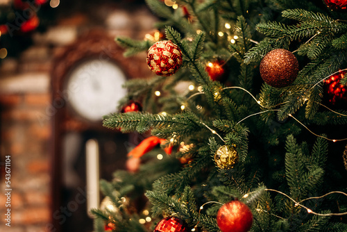 Red and gold Christmas decorations on the Christmas tree in the loft interior close-up.New Year's and Christmas background.Selective focus with shallow depth of field.