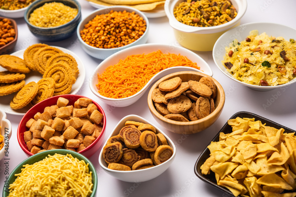 Indian Tea time snacks in group. Sev, chivda, farsan, mixture, bakarwadi served in different bowls Indian Tea time snacks in group. Sev, chivda, farsan, mixture, bakarwadi served in different bowls
