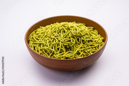 palak sev is a crispy crunchy green colored spinach flavored fried farsan with salt, spice powder